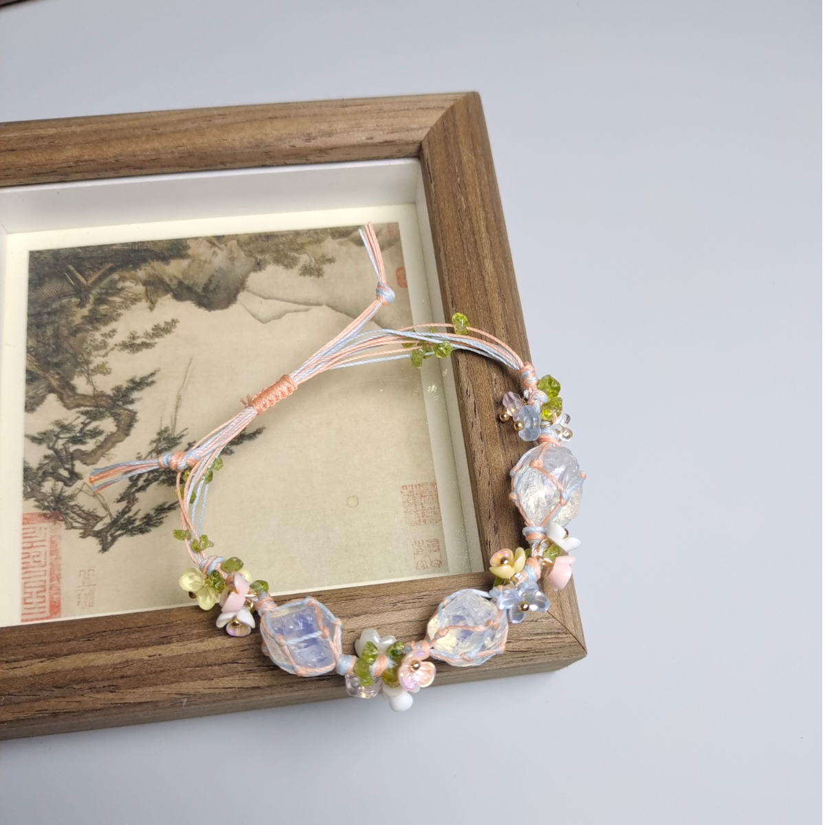 Opal gemstone bracelet with wire wrapping shown alongside raw crystals for a balanced healing display