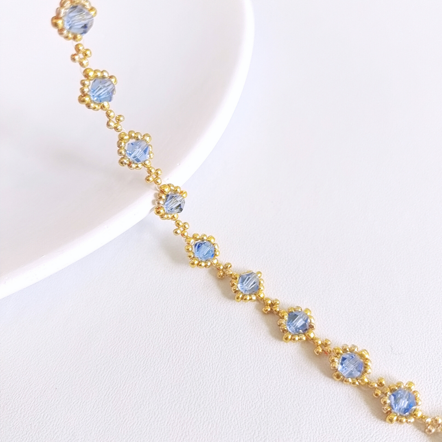 Detailed view of handmade bracelet with sky blue beads