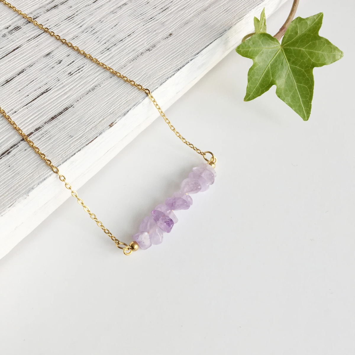Close-up of raw amethyst chips in handcrafted necklace