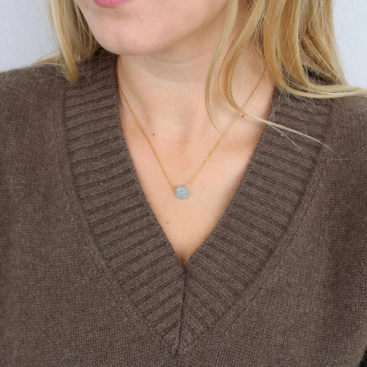 Aquamarine raw stone necklace worn on neck