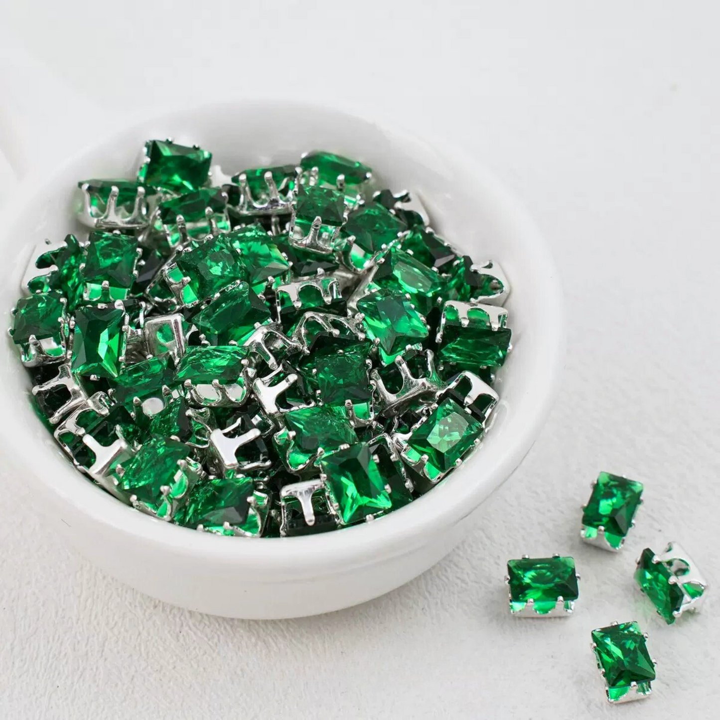Forest green rectangular zirconia in silver-tone claw settings
