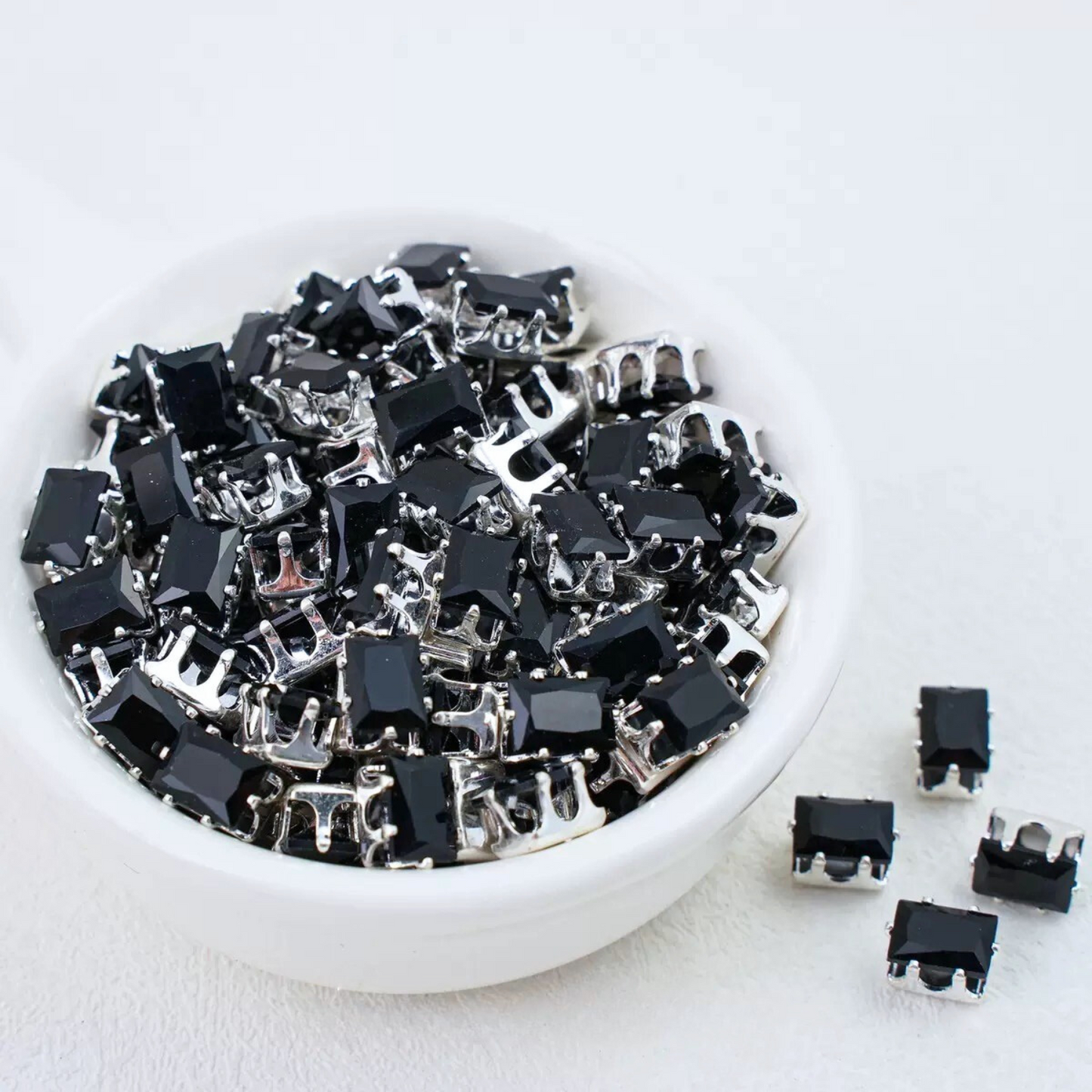 Black rectangular zirconia in silver-tone claw settings