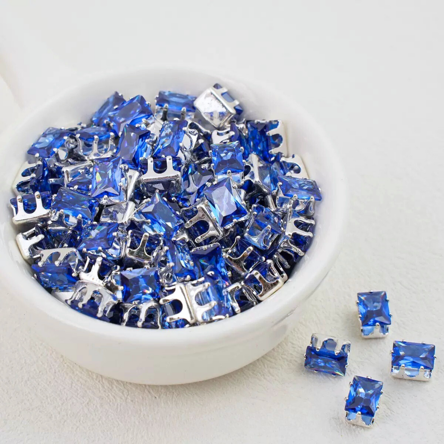 Ocean blue rectangular zirconia in silver-tone claw settings