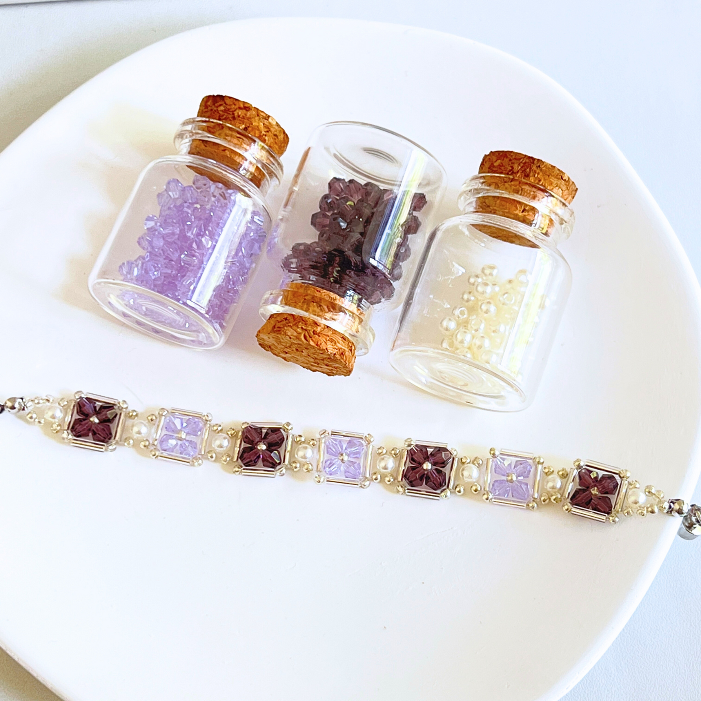 Grape purple beaded bracelet and materials display