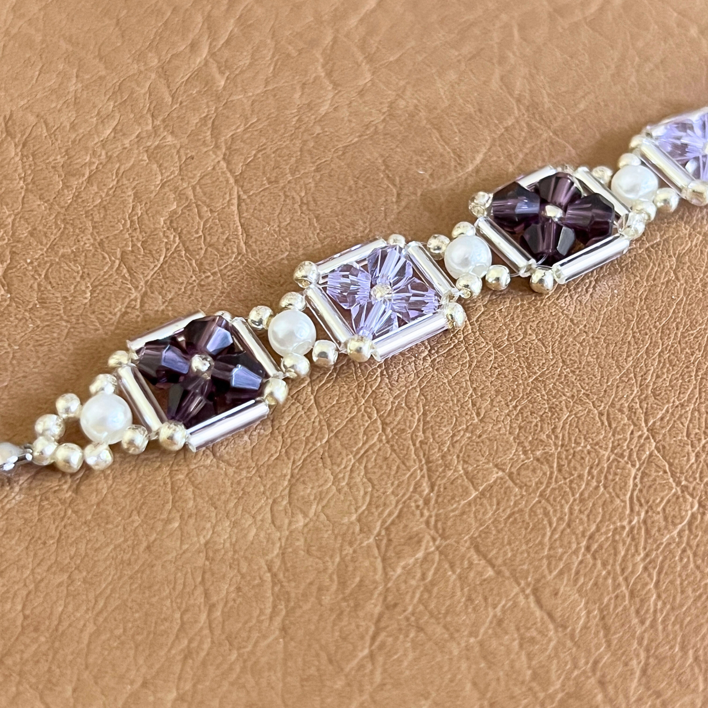Close-up of hand-beaded bracelet in grape purple