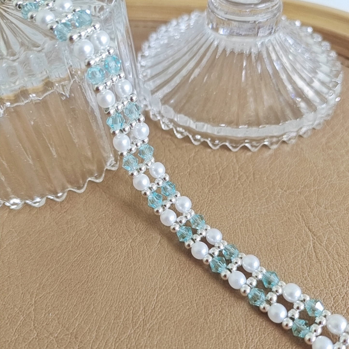 Close-up of icy blue crystal diamond beads on handmade bracelet
