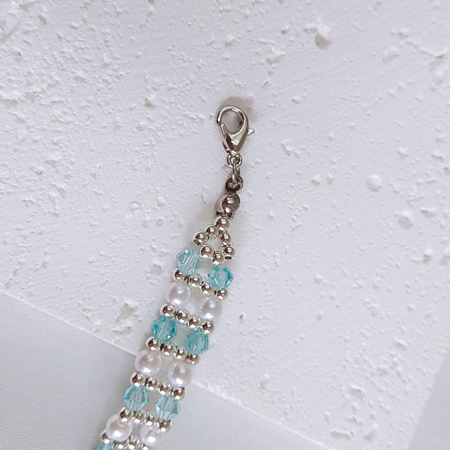 Macro shot of handmade bracelet with ice blue diamond crystals