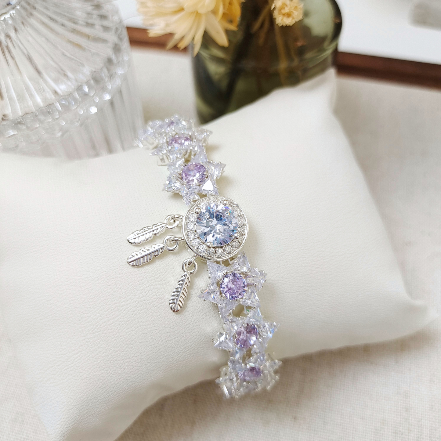 Close-up of six-pointed star bracelet with white and purple zircon