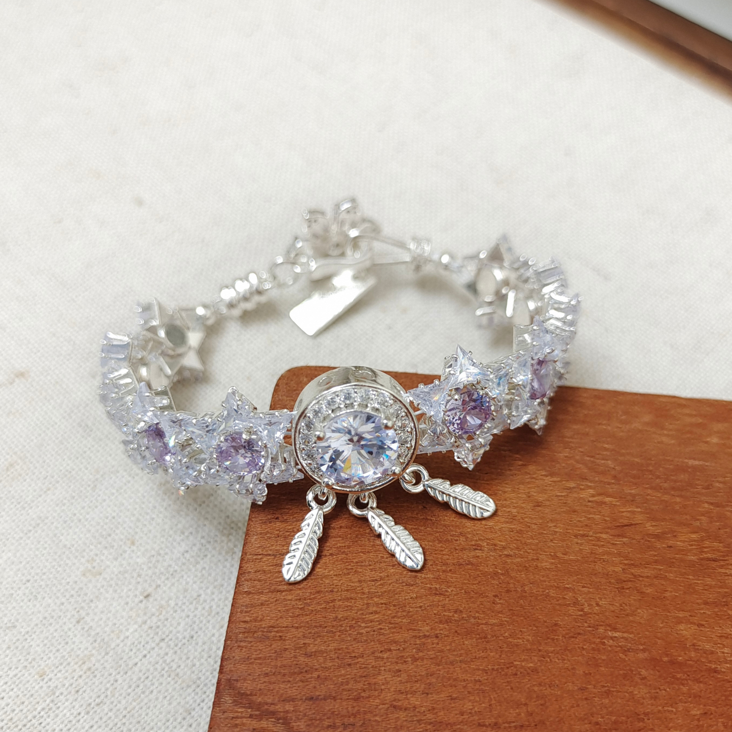 Detail of six-pointed star zircon bead with dreamcatcher spacer charm