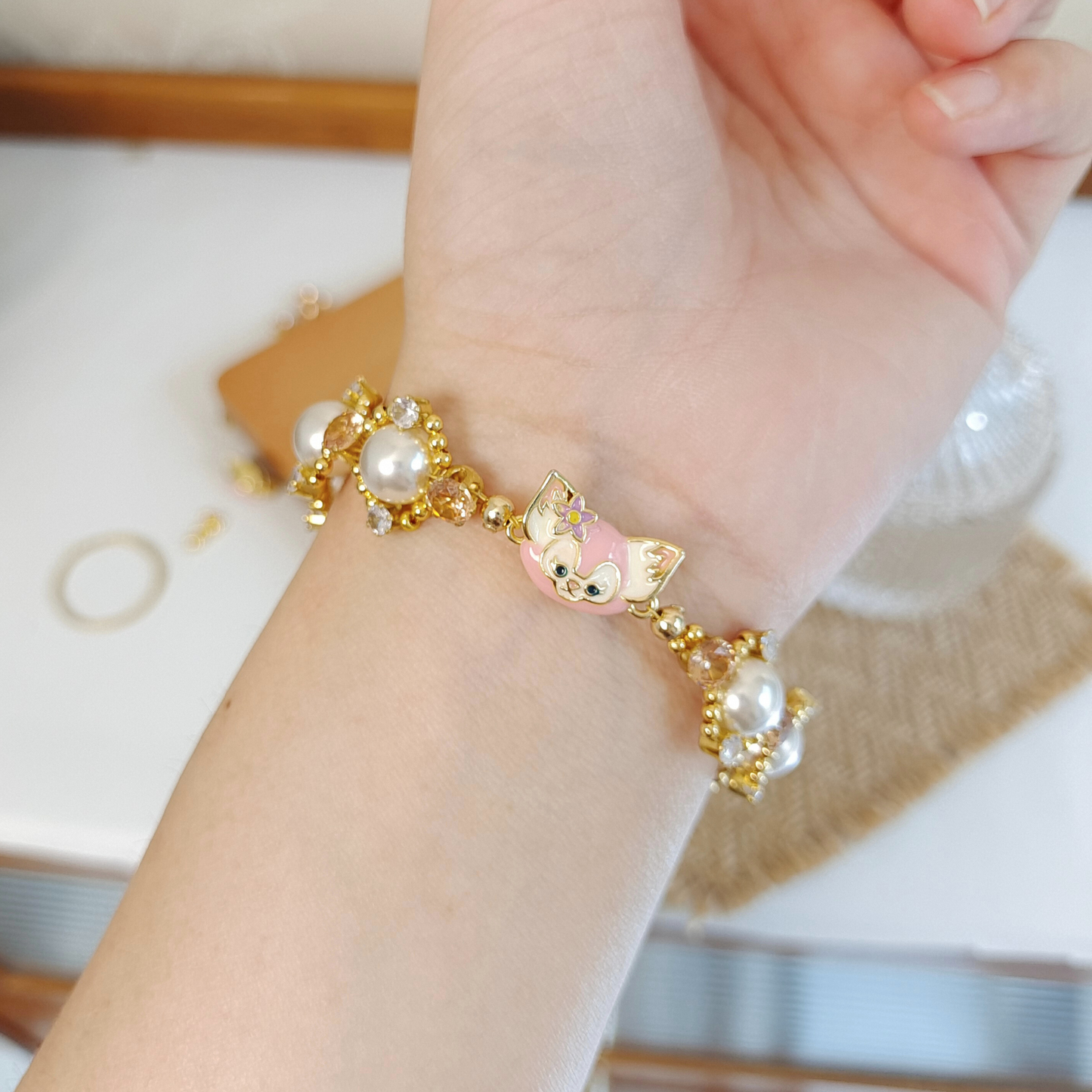 Wrist wearing LinaBell clasp pearl bracelet in natural light