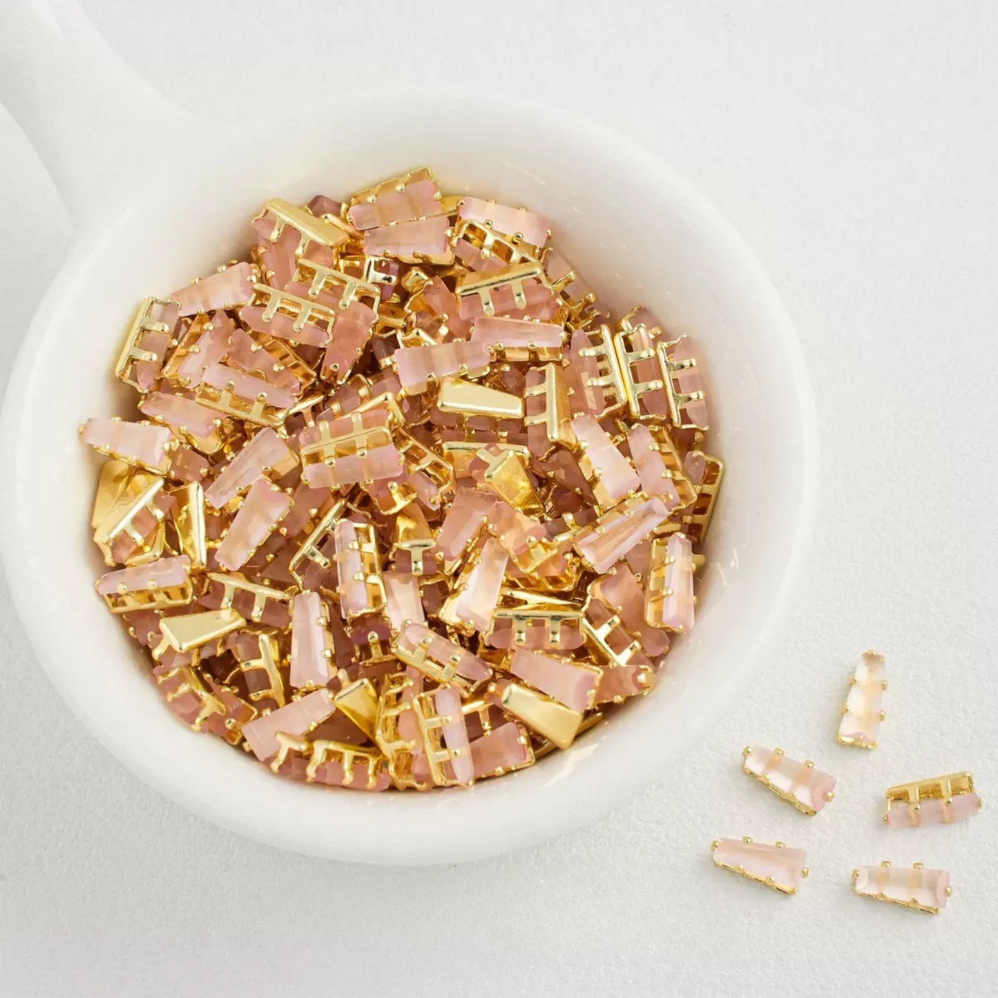 Cat eye pink trapezoid-shaped zircon spacer with gold backing