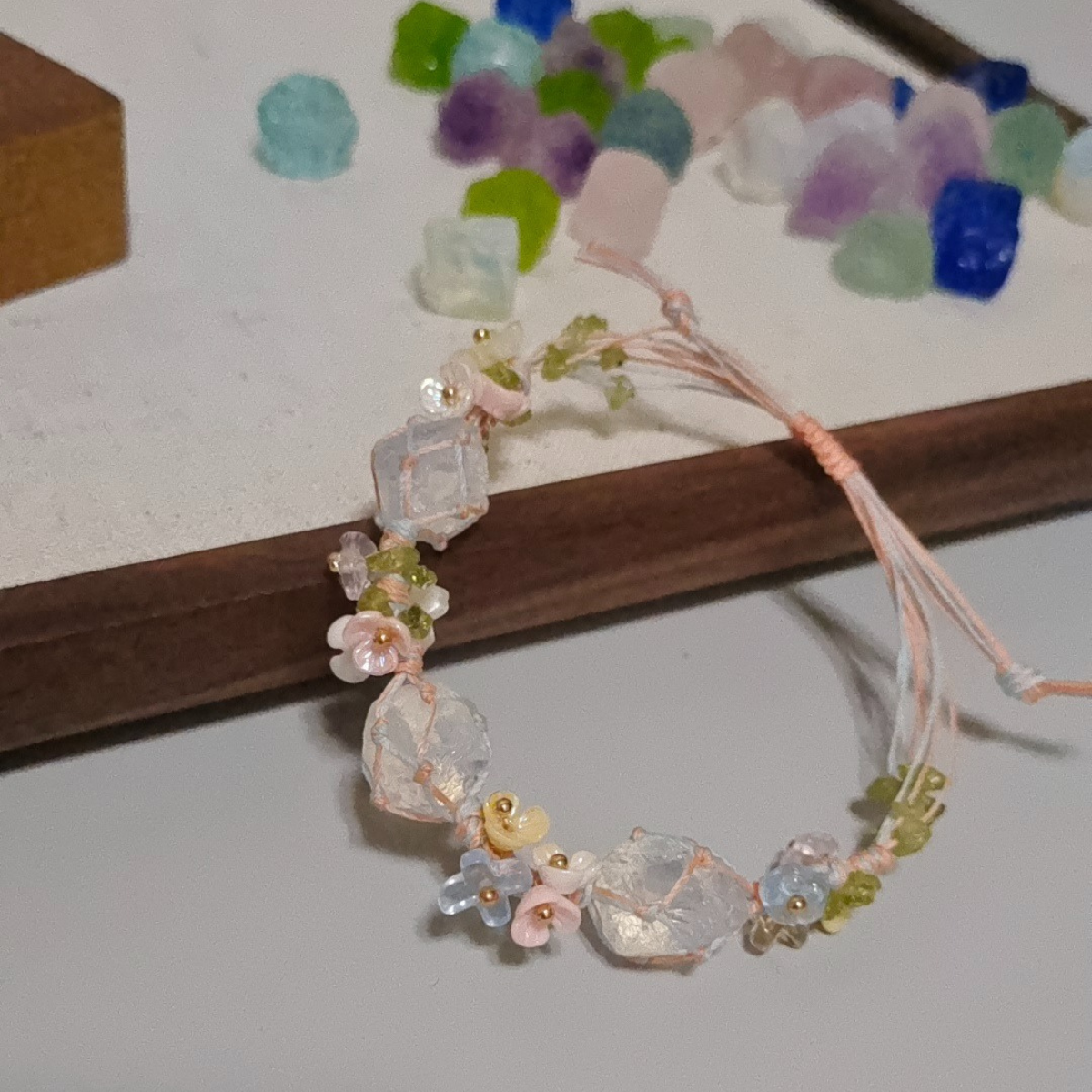 Full view of opal wire-wrapped bracelet paired with raw healing crystals