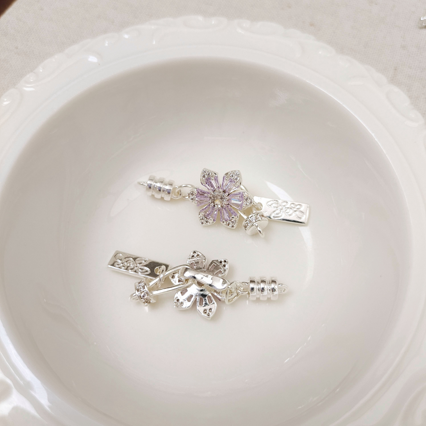 Sakura-shaped purple zircon clasp front and back sides
