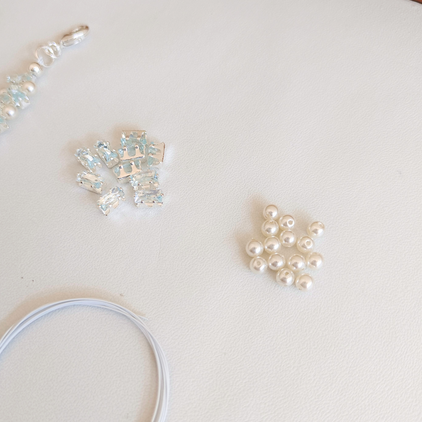 Blue zircon and pearl bracelet alongside complete jewelry-making materials