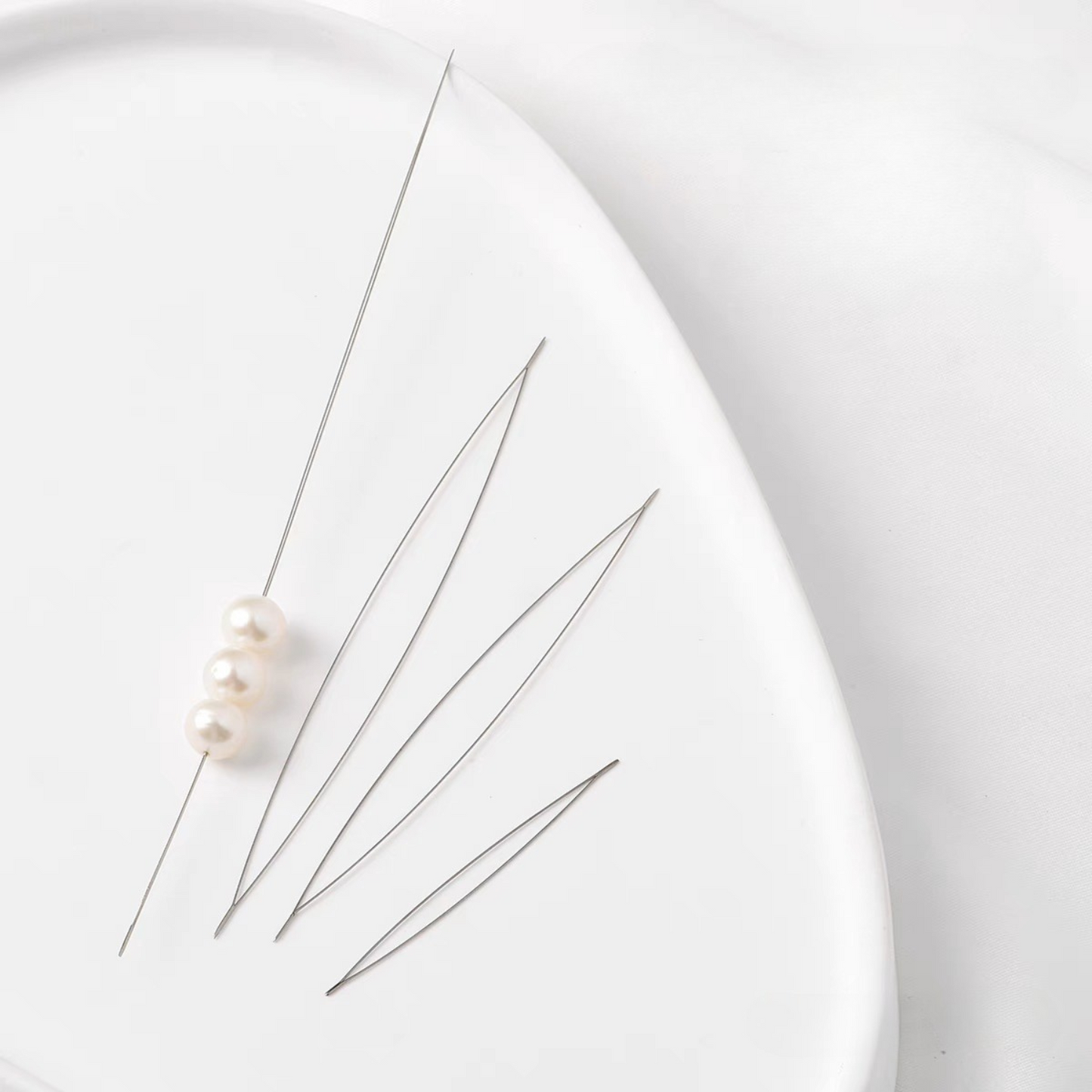 Three beading needle sizes displayed