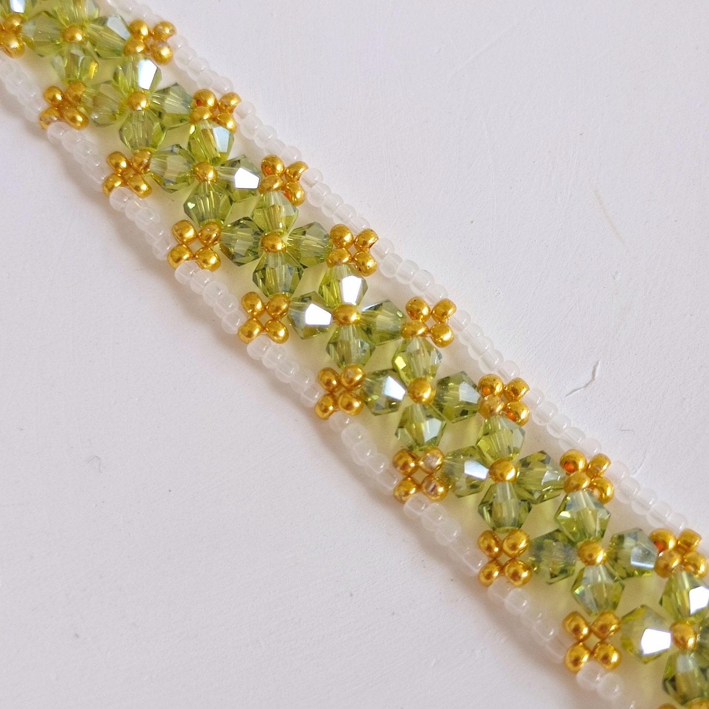 Close-up detail of olive green beaded bracelet