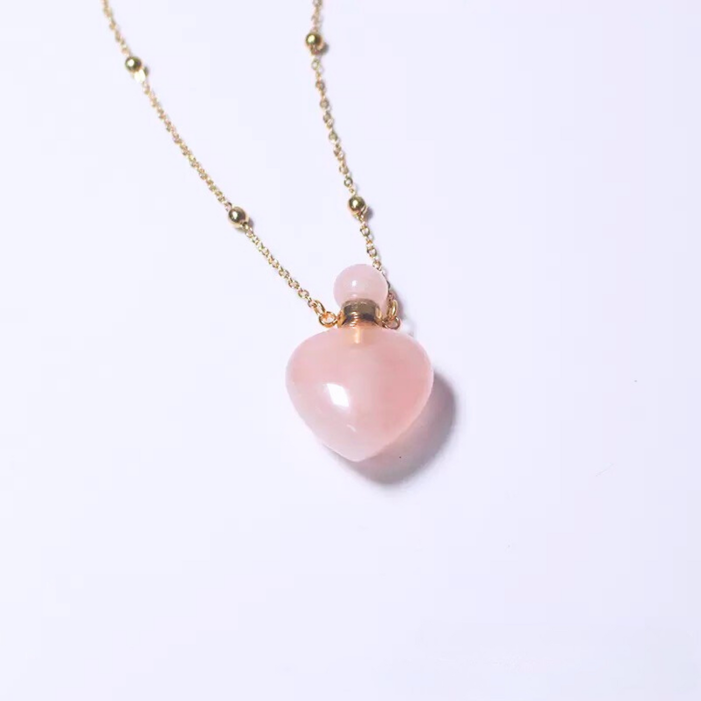 Front view of rose quartz crystal perfume bottle pendant