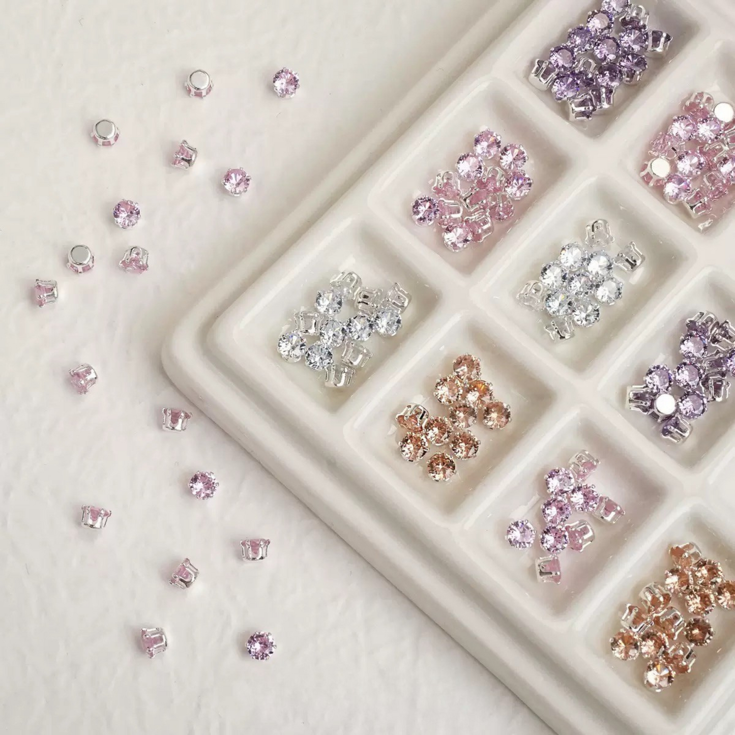 Assorted round CZ gems with claw settings