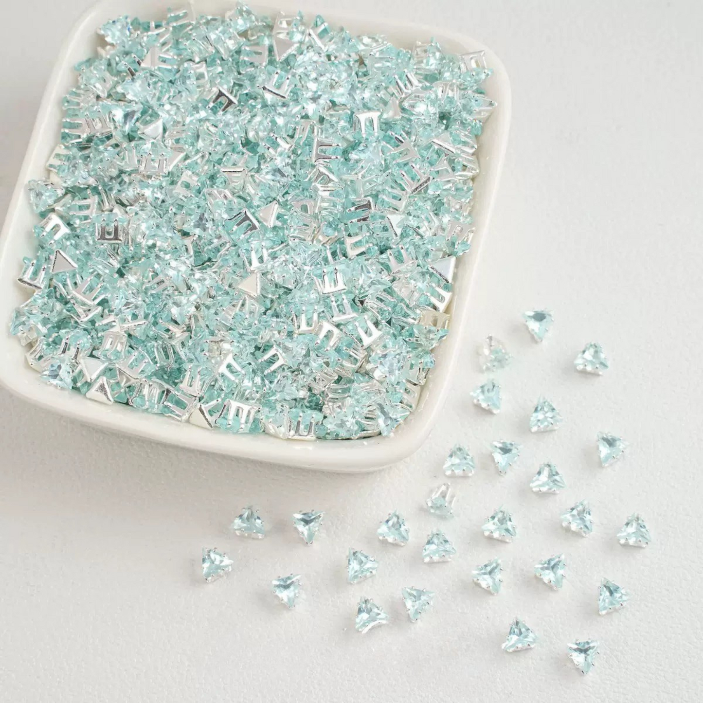 Ice blue faceted triangle zirconia beads set on silver backing