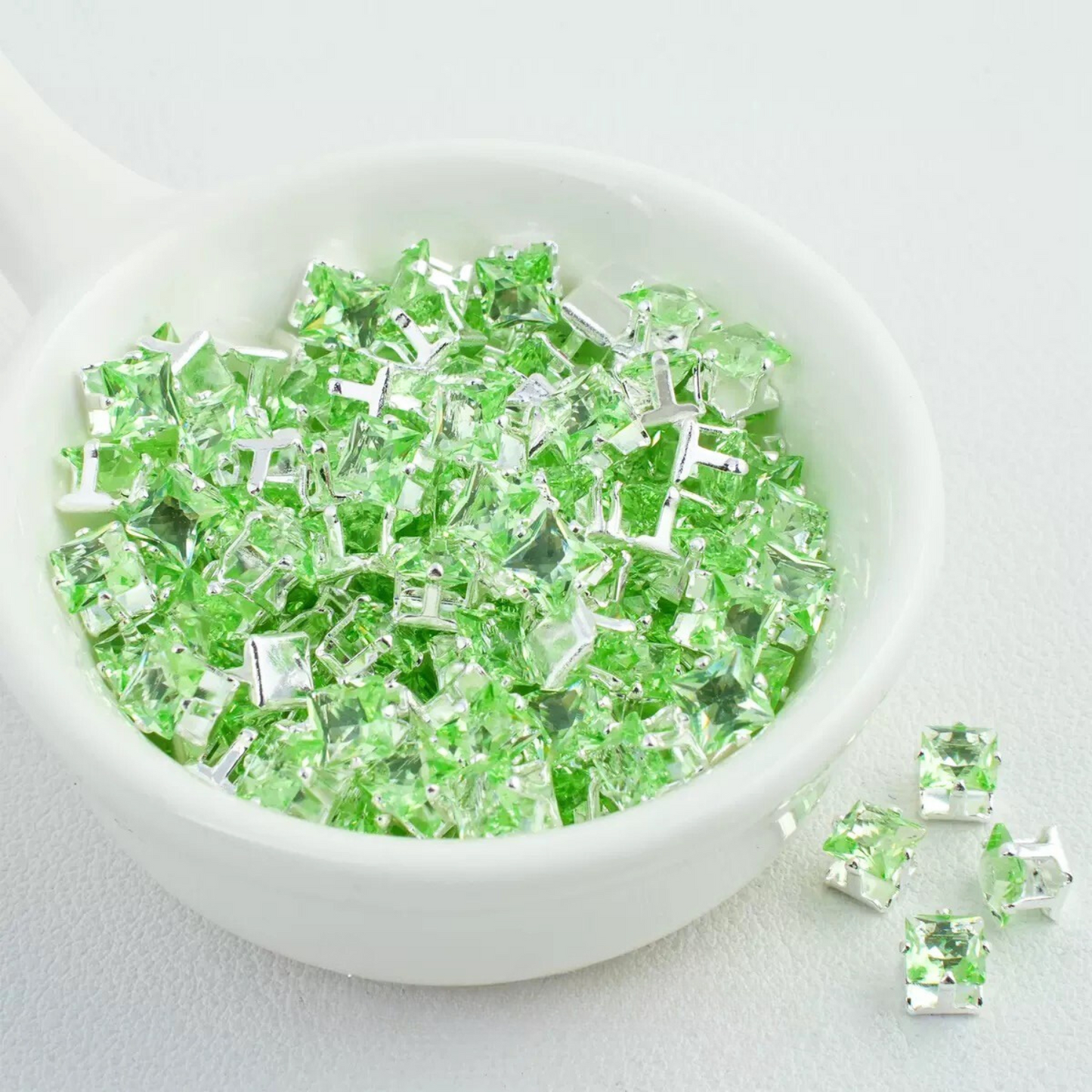 Precision-cut apple green square CZ in silver-plated prong settings