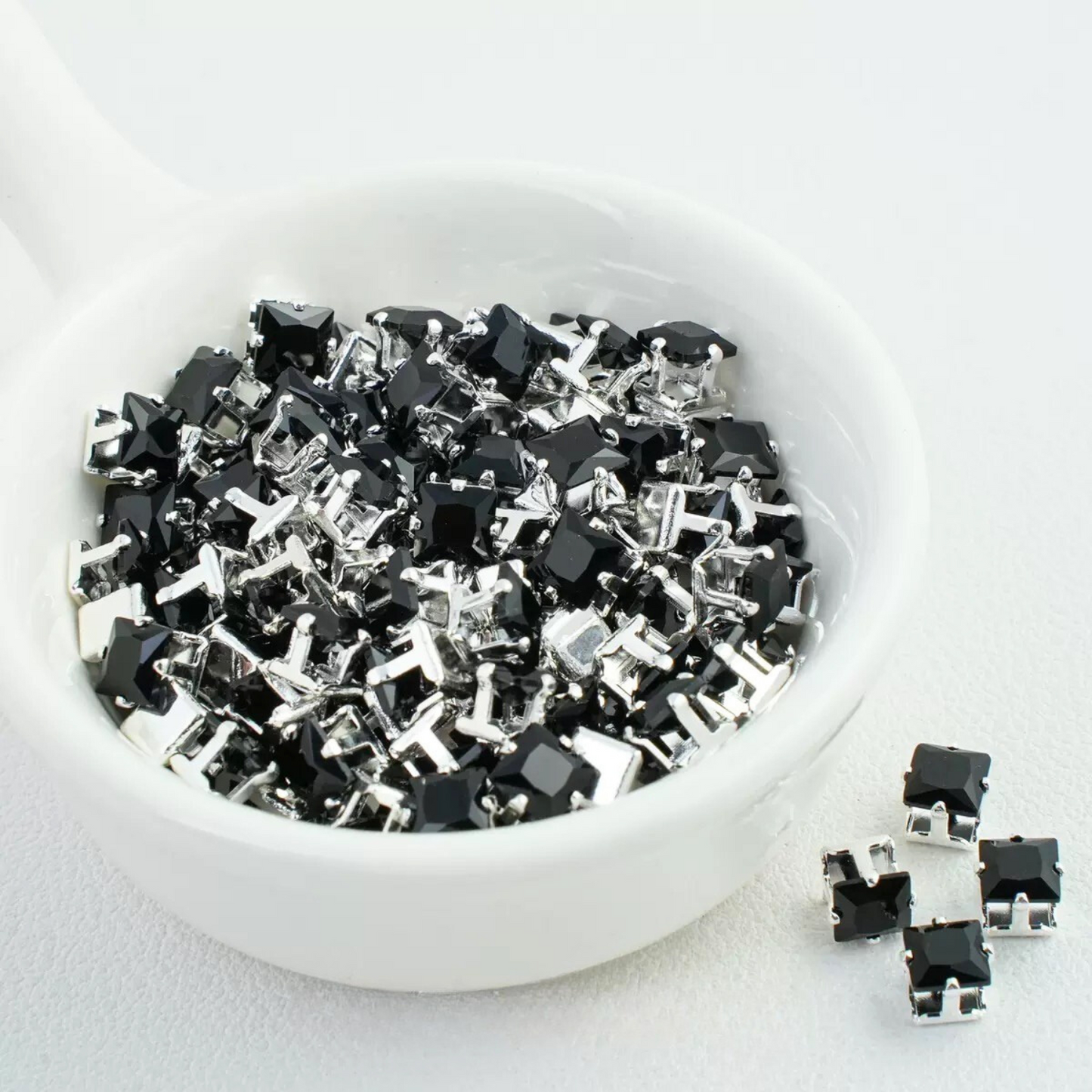 Precision-cut black square CZ in silver-plated prong settings