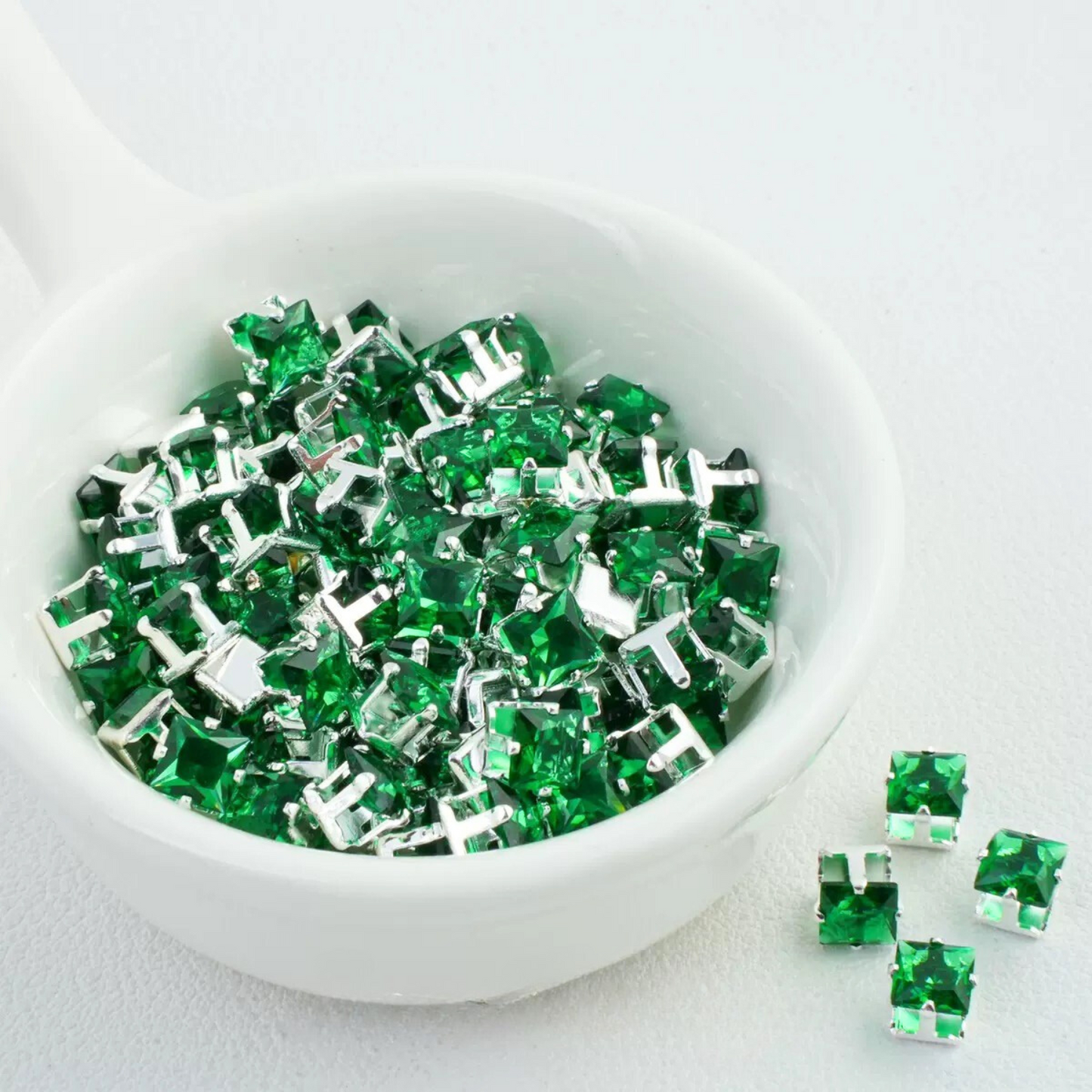 Precision-cut forest green square CZ in silver-plated prong settings