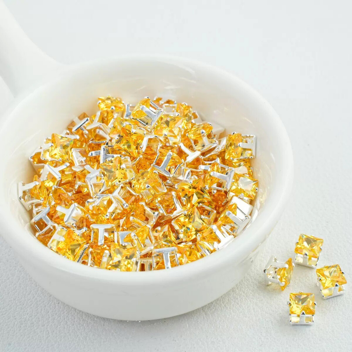 Precision-cut yellow square CZ in silver-plated prong settings