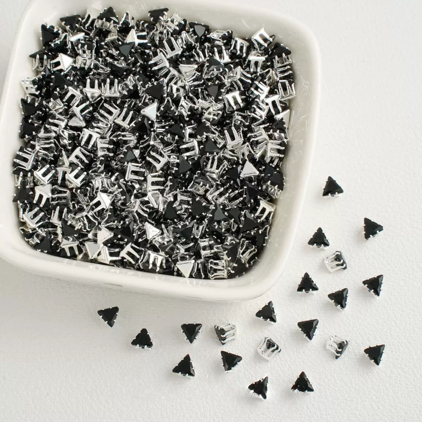 Black faceted triangle zirconia beads set on silver backing
