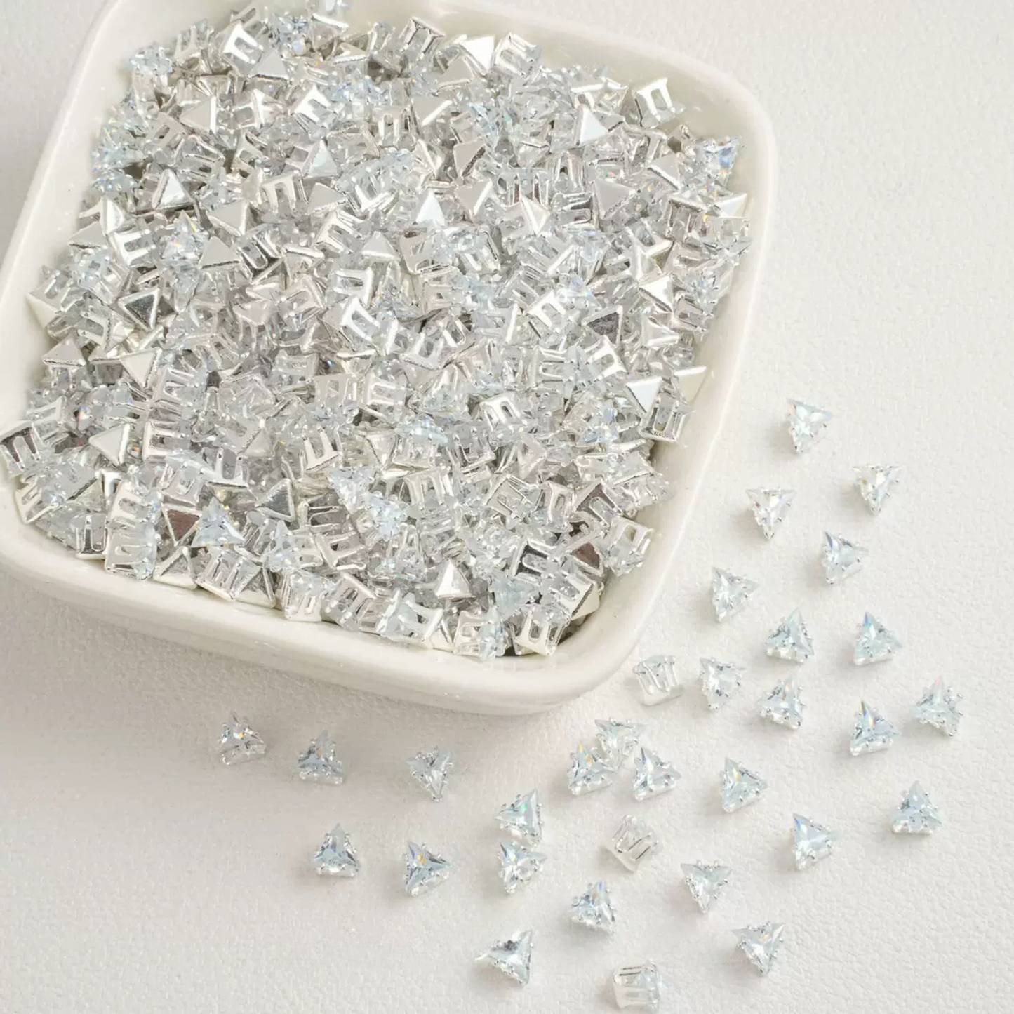 Clear faceted triangle zirconia beads set on silver backing