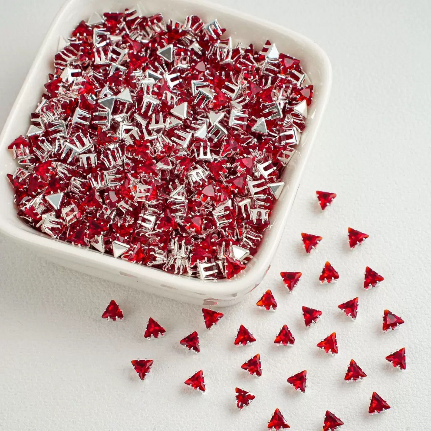 Red faceted triangle zirconia beads set on silver backing