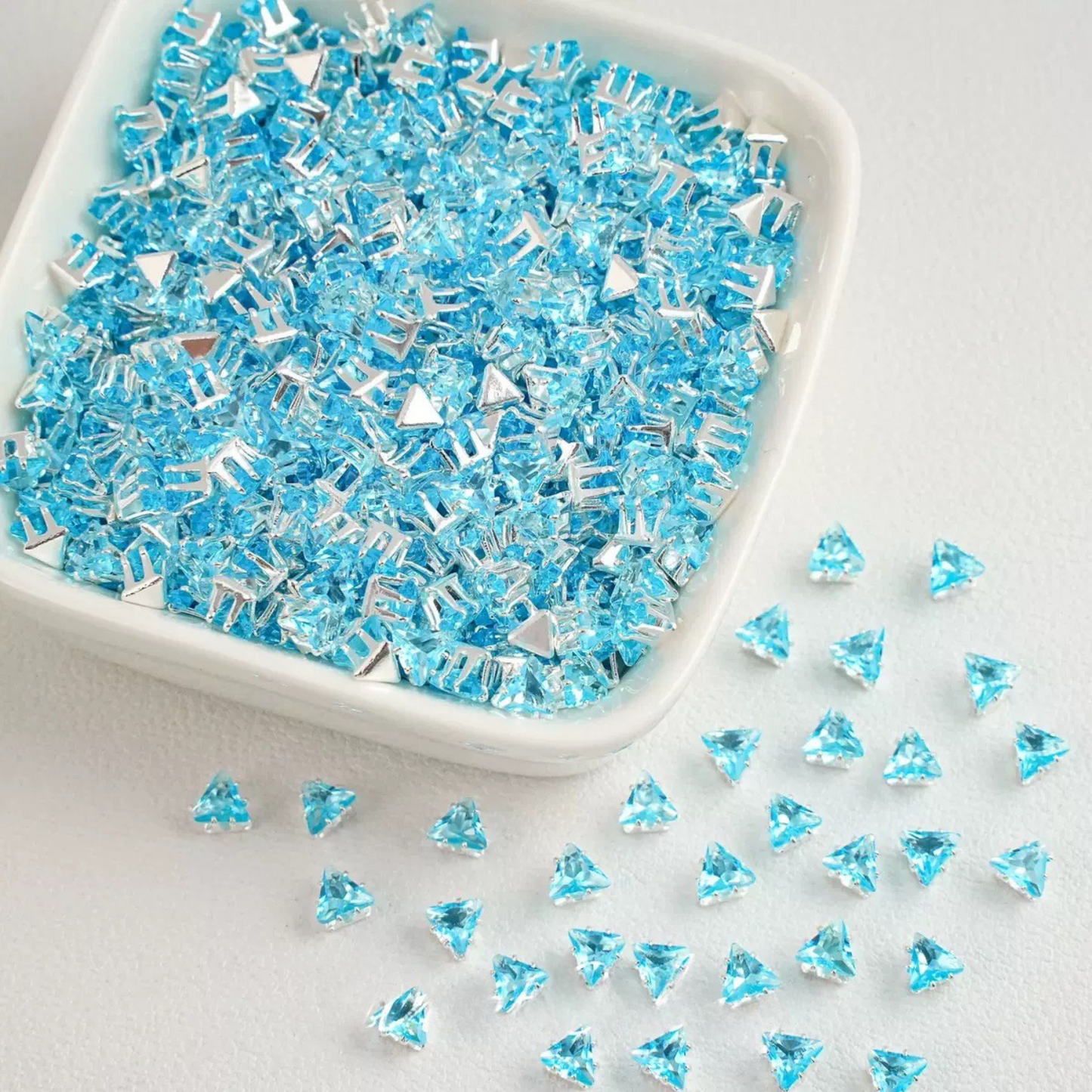 Sky blue faceted triangle zirconia beads set on silver backing