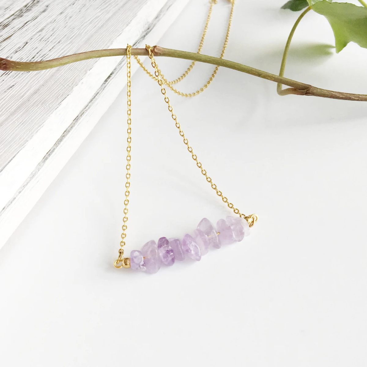 Close-up section of handmade necklace with unpolished amethyst chips