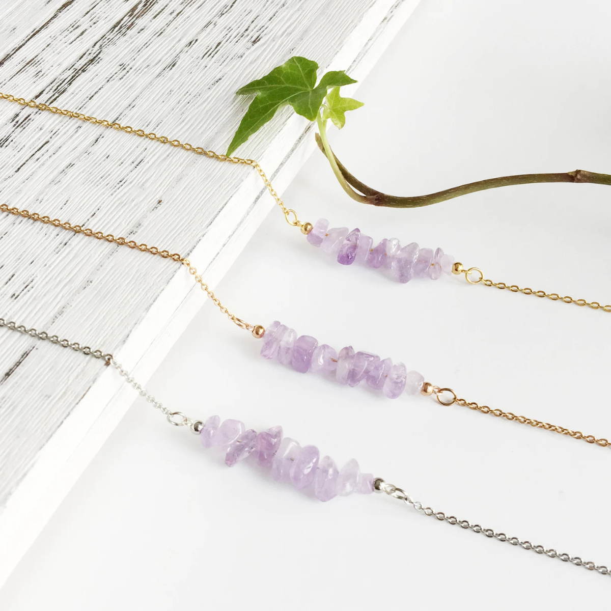 Close-up of handmade amethyst chip necklace showing raw crystal texture and natural purple tones
