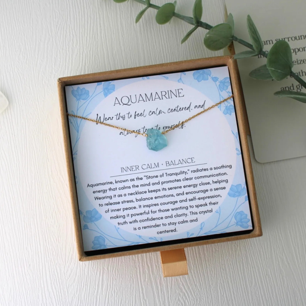 Aquamarine necklace with raw crystal, elegantly packaged in branded jewelry box for luxury gifting