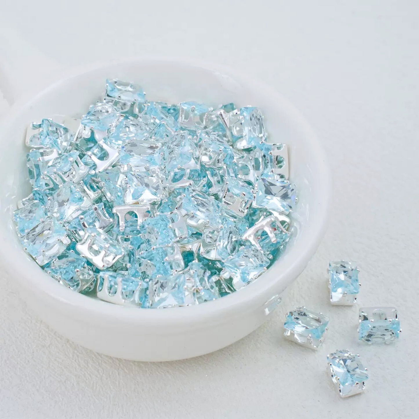 Sky blue rectangular zirconia in silver-tone claw settings