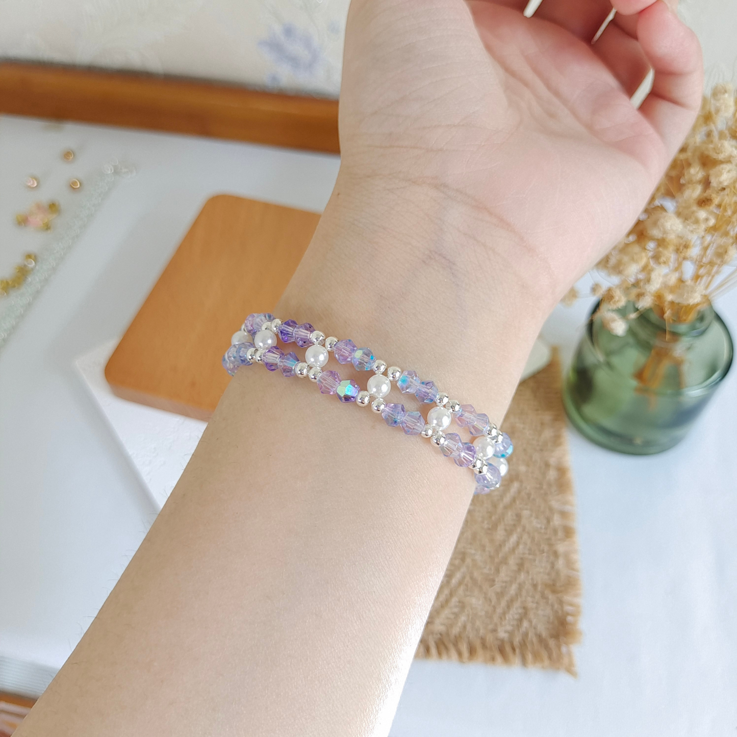 Handmade aurora purple bracelet worn on wrist
