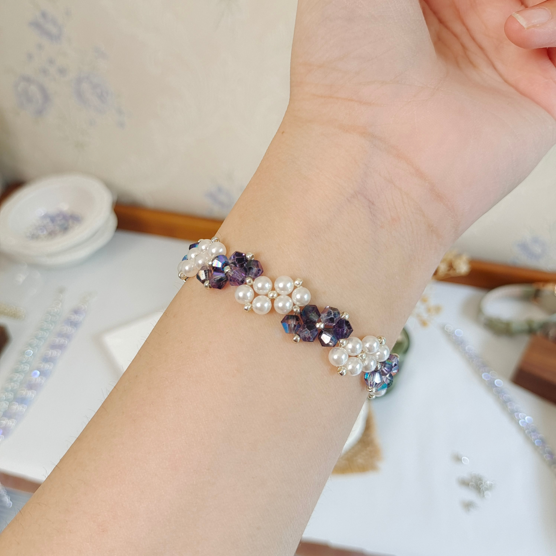Ink blue diamond bead and pearl bracelet worn on wrist