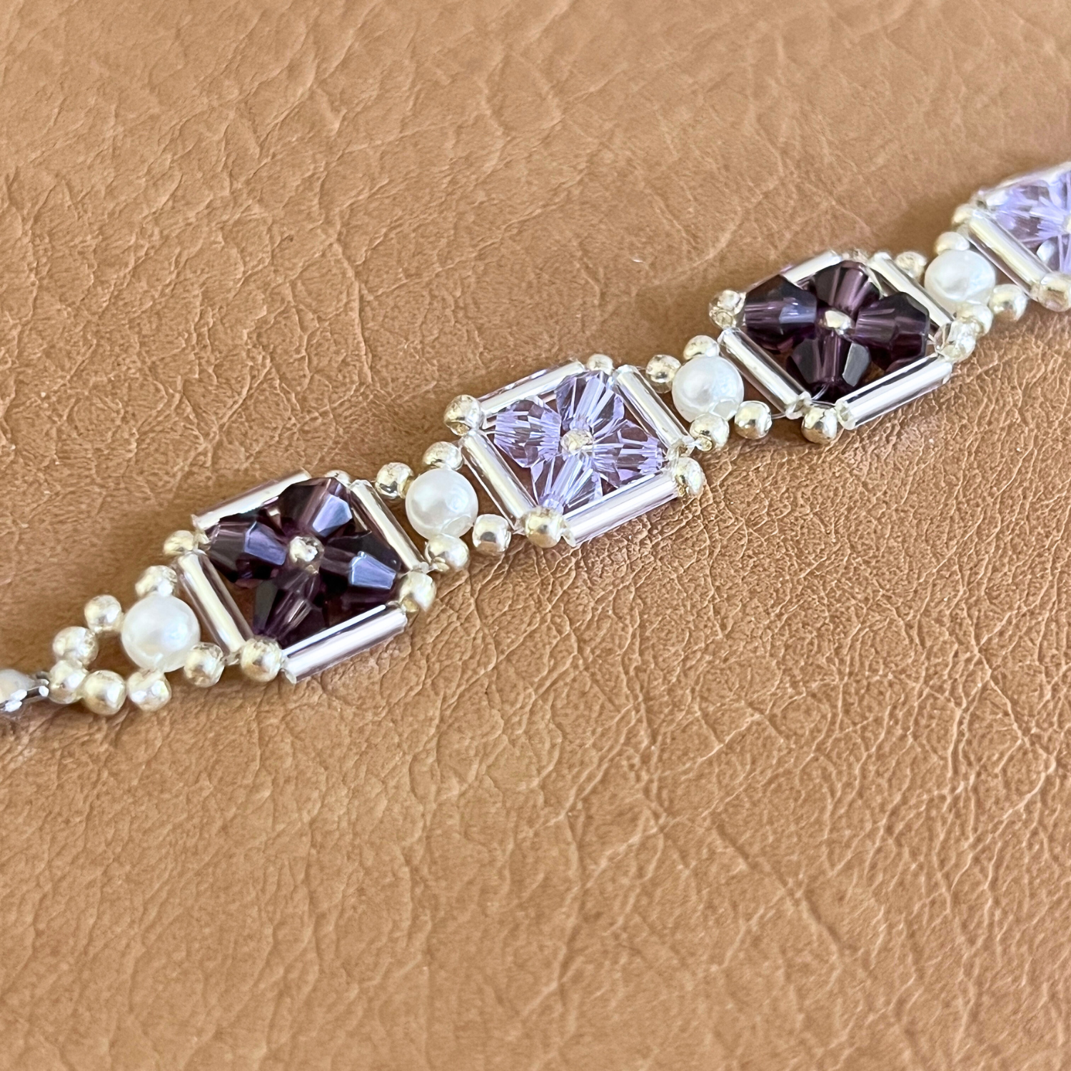 Close-up of hand-beaded bracelet in grape purple