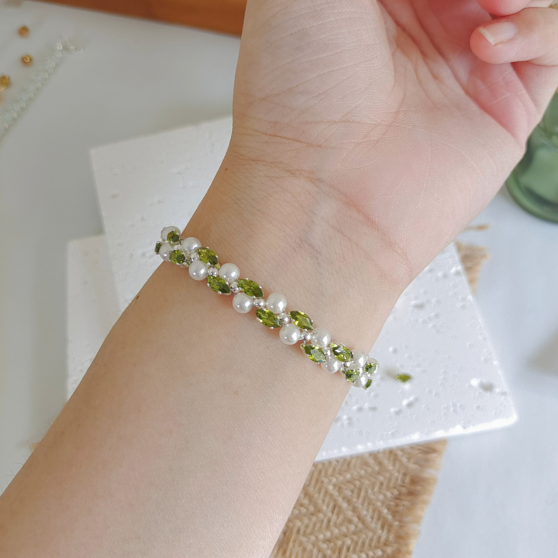 Olive green marquise zircon and pearl handmade bracelet worn on wrist