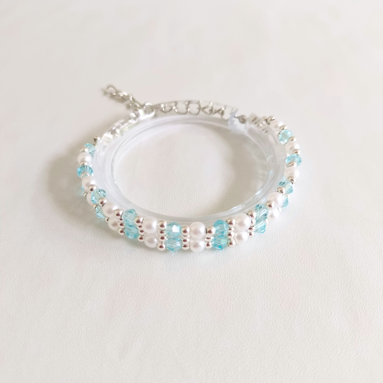 Frosty blue diamond-shaped crystal beads in a handmade bracelet