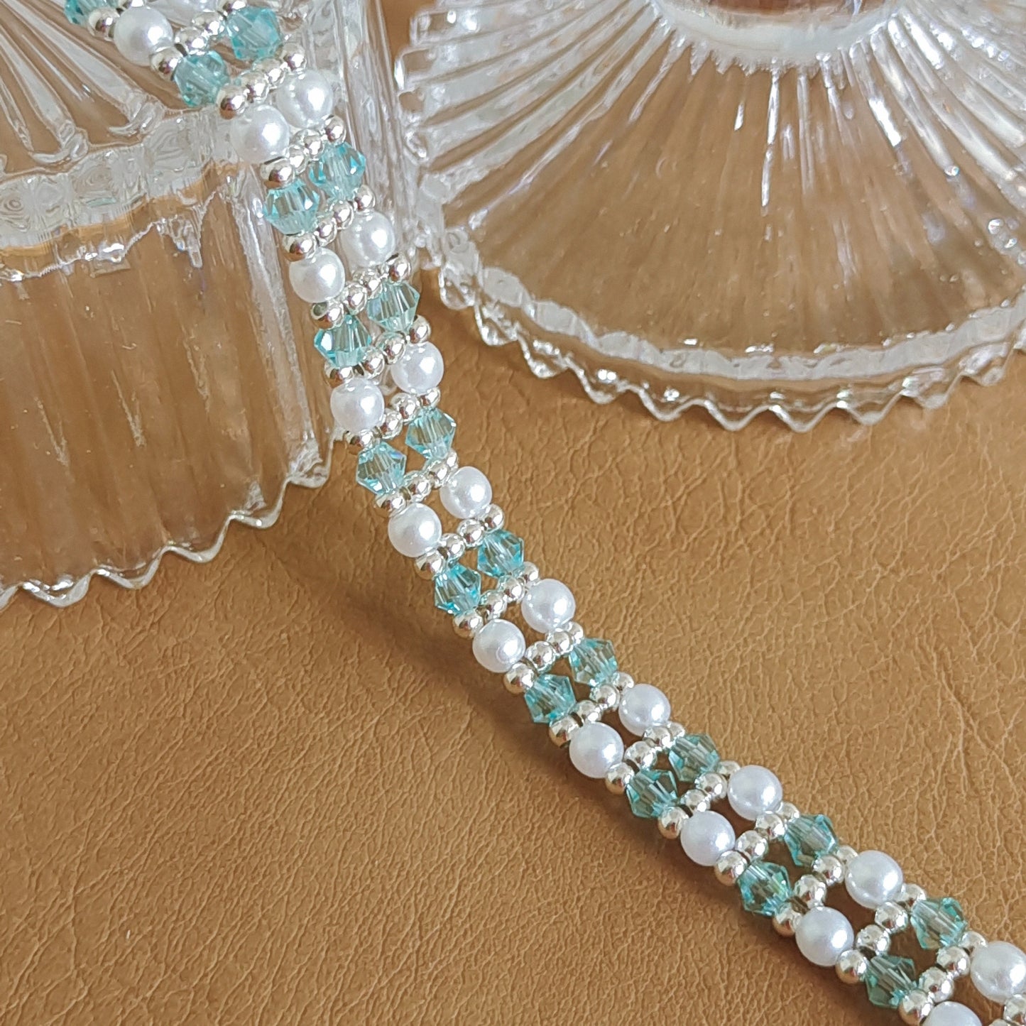 Close-up of ice blue crystal beads and white pearls on handmade bracelet