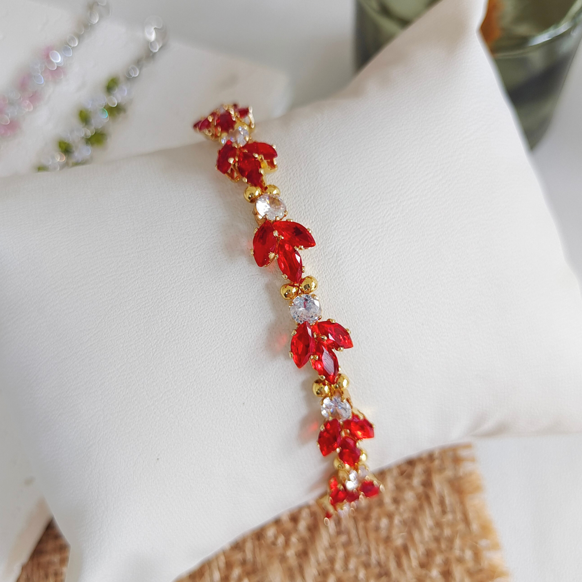 Close-up of koi fish zircon charm on handmade beaded bracelet