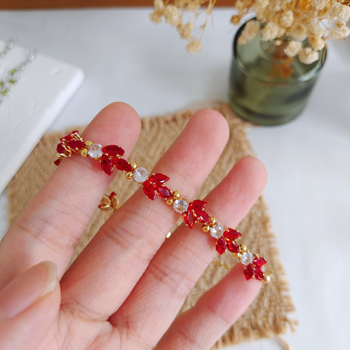 Lucky koi charm bracelet with claw-set zircon shown on wrist