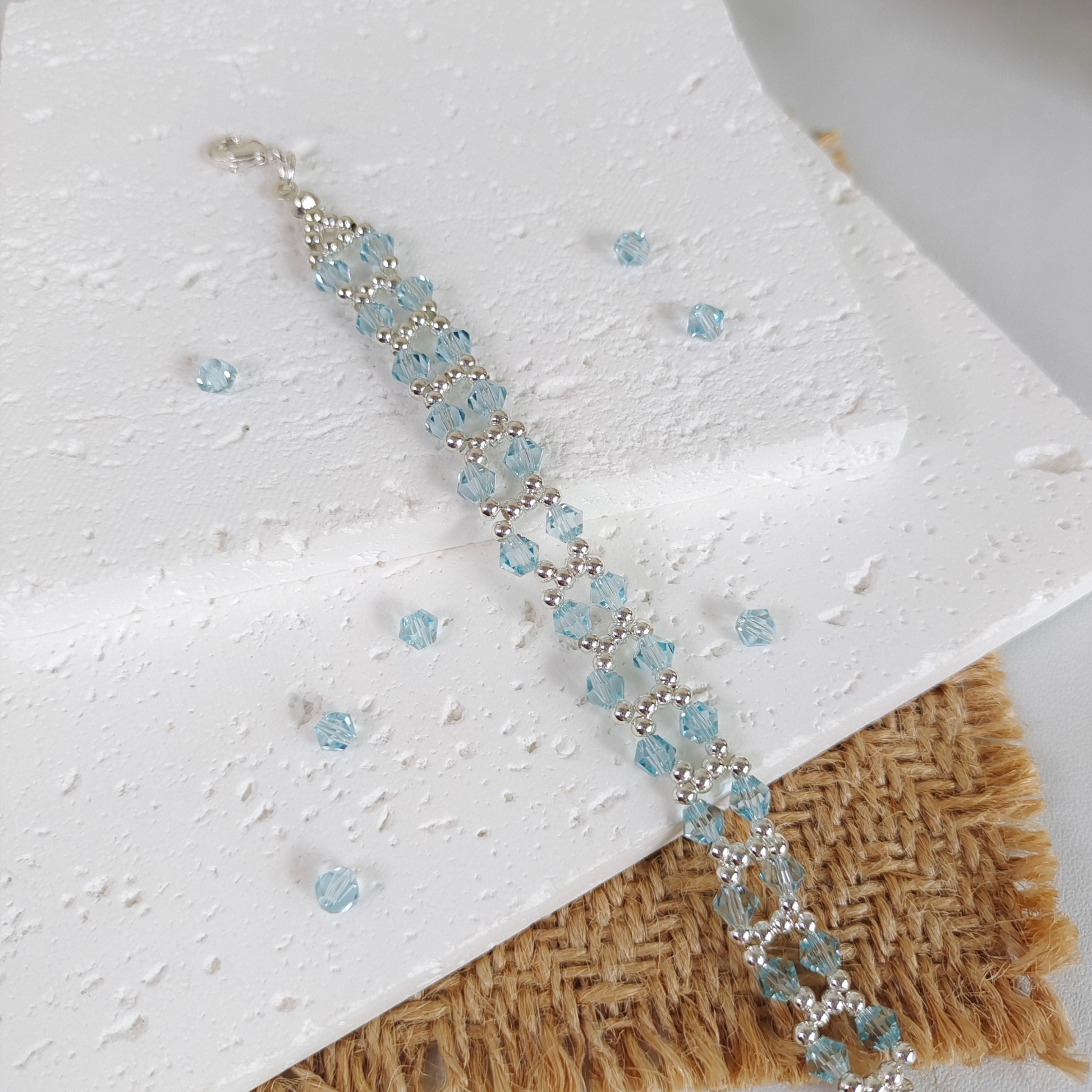 Icy lake blue beaded bracelet laid flat for display