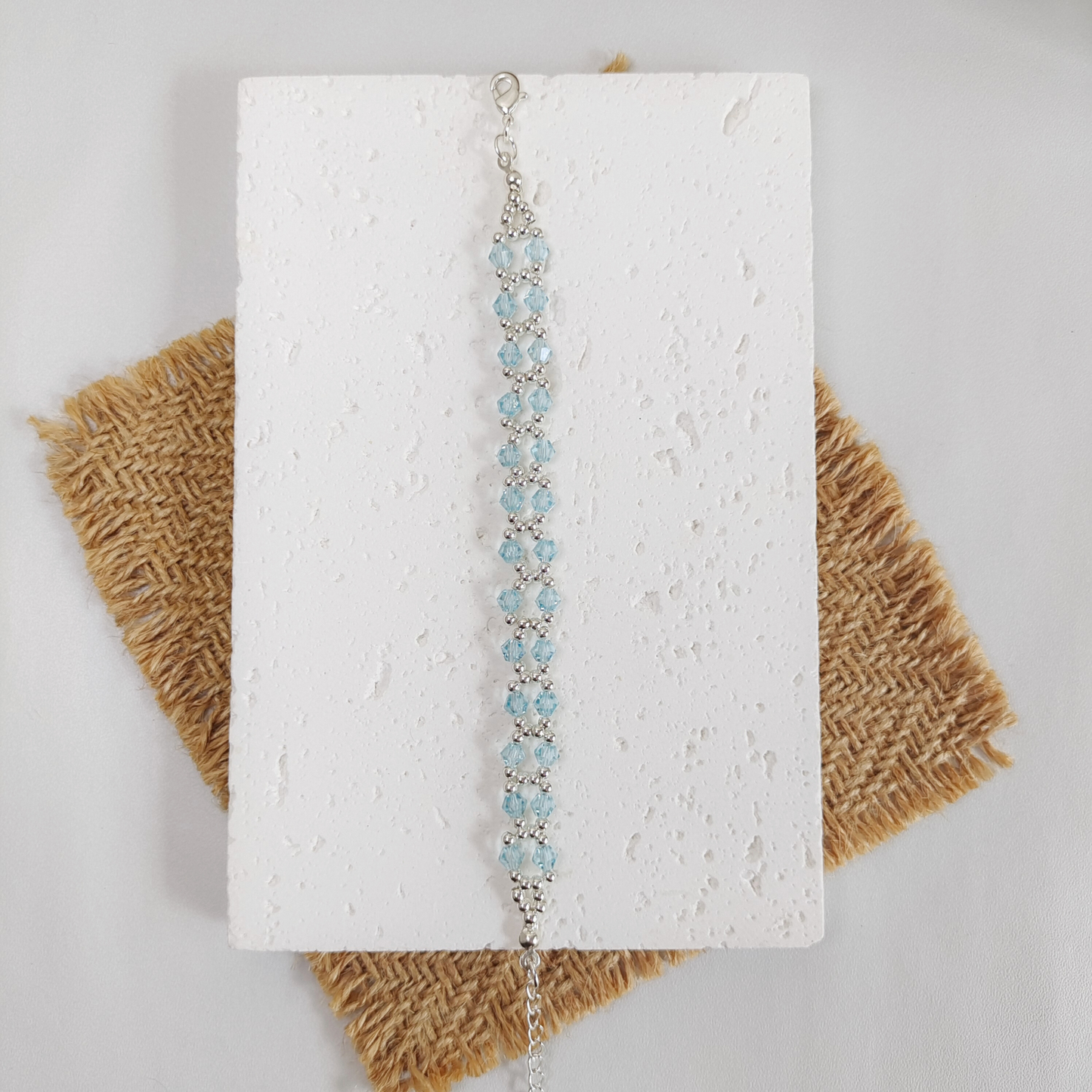 Flat lay of icy blue crystal and silver seed bead bracelet
