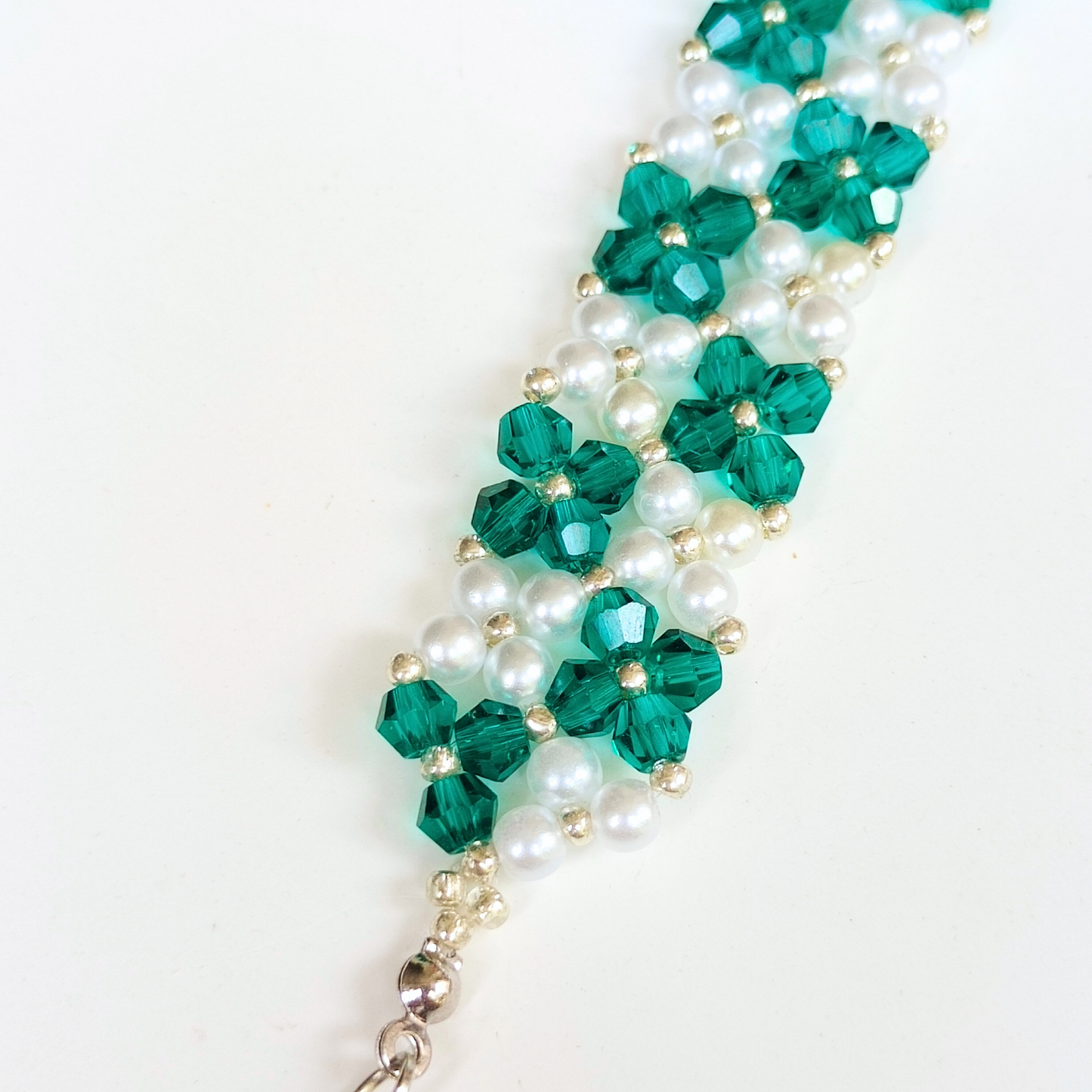 Close-up of handmade peacock green beaded bracelet
