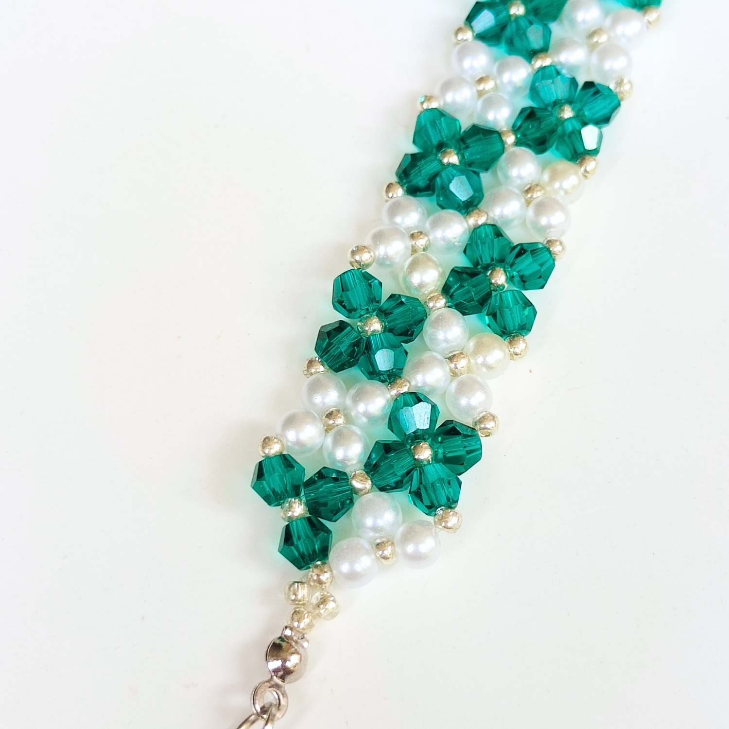 Close-up of handmade peacock green beaded bracelet