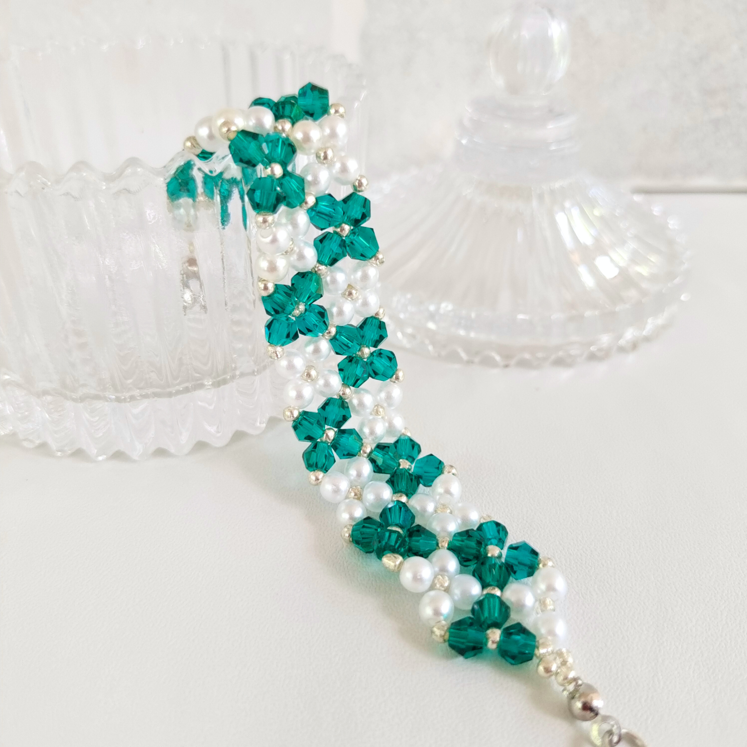 Detailed view of handmade bracelet with peacock green seed beads