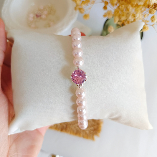 Zoomed-in view of blush pearls and crystal accents