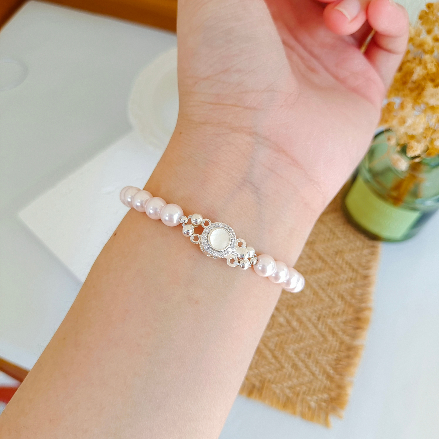 Pink pearl bracelet with crystal spacers worn on wrist